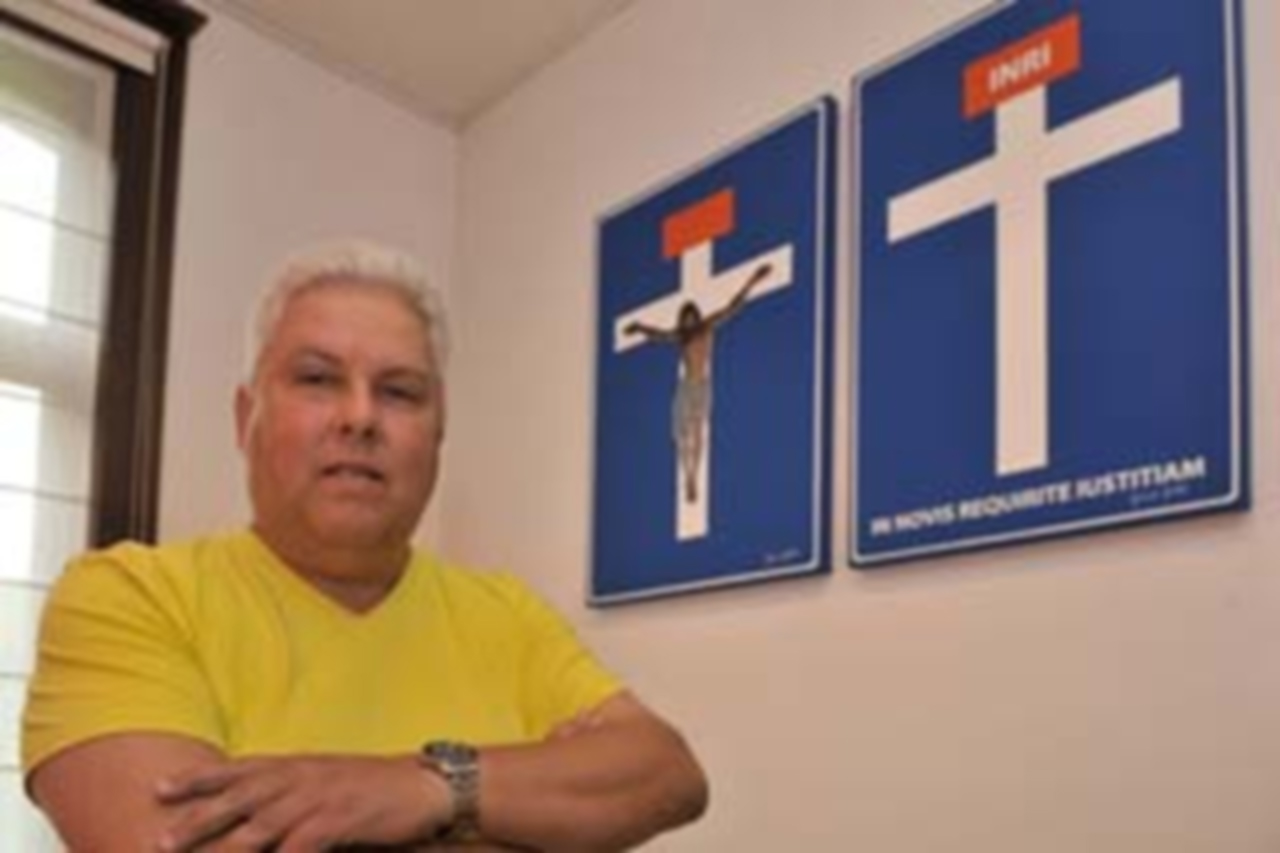 Man with cross posters